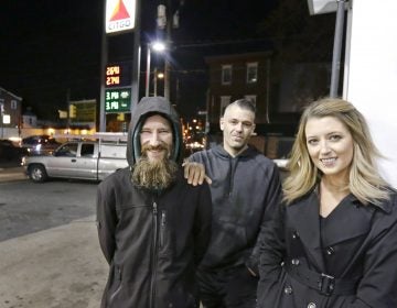 Johnny Bobbitt Jr., (left), Kate McClure, and Mark D'Amico pose at a gas station