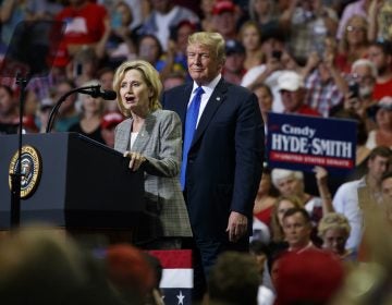 President Donald Trump watches as Sen. Cindy Hyde-Smith, R-Miss., speaks during a campaign rally at the Landers Center Arena, Tuesday, Oct. 2, 2018, in Southaven, Miss. (AP Photo/Evan Vucci)
