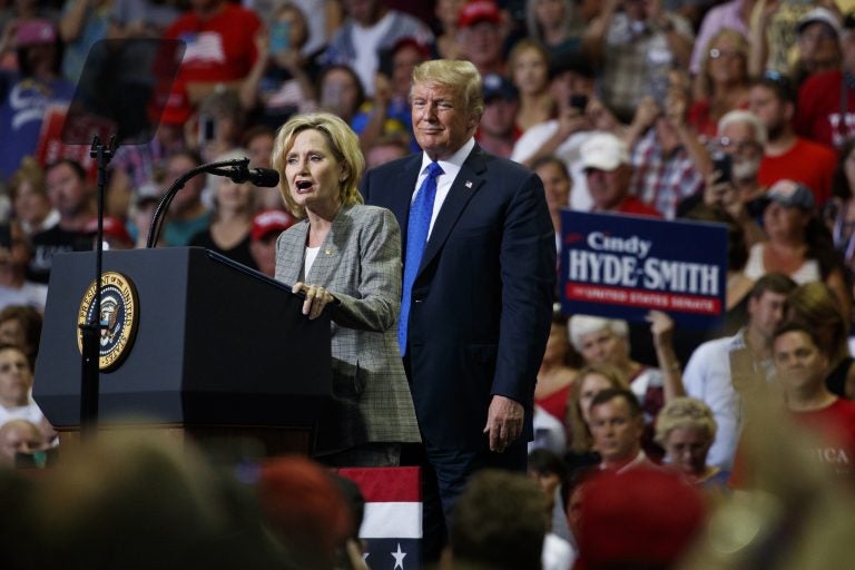 President Donald Trump watches as Sen. Cindy Hyde-Smith, R-Miss., speaks during a campaign rally at the Landers Center Arena, Tuesday, Oct. 2, 2018, in Southaven, Miss. (AP Photo/Evan Vucci)