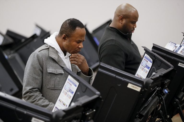 Voters use electronic polling machines as they cast their votes early at the Franklin County Board of Elections, Wednesday, Oct. 31, 2018, in Columbus, Ohio. (John Minchillo/AP Photo)