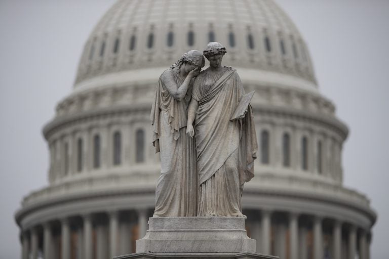 The Capitol Dome looms behind the Peace Monument statue on a rainy Election Day in Washington, Tuesday, Nov. 6, 2018.  (AP Photo/J. Scott Applewhite)