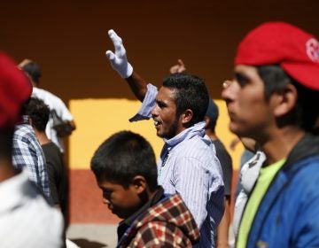 A group of Central American migrants, representing the thousands participating in a caravan trying to reach the U.S. border, undertake an hours-long march to the office of the United Nations' humans rights body in Mexico City, Thursday, Nov. 8, 2018. Members of the caravan which has stopped in Mexico City demanded buses Thursday to take them to the U.S. border, saying it is too cold and dangerous to continue walking and hitchhiking.(AP Photo/Rebecca Blackwell)
