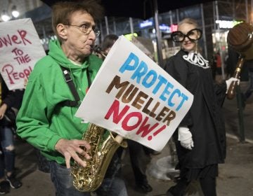 Protesters march through Times Square during a demonstration in support of special counsel Robert Mueller, Thursday, Nov. 8, 2018, in New York. A protest in New York City has drawn several hundred people calling for the protection of Mueller's investigation into potential coordination between Russia and President Donald Trump's campaign. (Mary Altaffer/AP Photo)