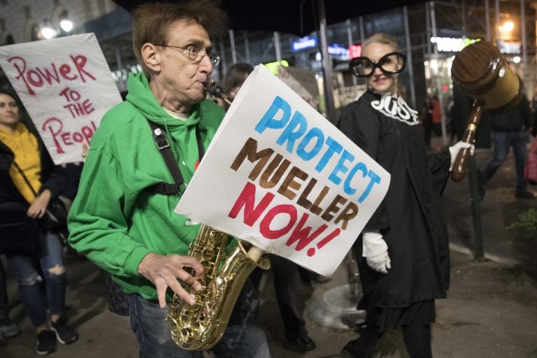 Protesters march through Times Square during a demonstration in support of special counsel Robert Mueller, Thursday, Nov. 8, 2018, in New York. A protest in New York City has drawn several hundred people calling for the protection of Mueller's investigation into potential coordination between Russia and President Donald Trump's campaign. (Mary Altaffer/AP Photo)