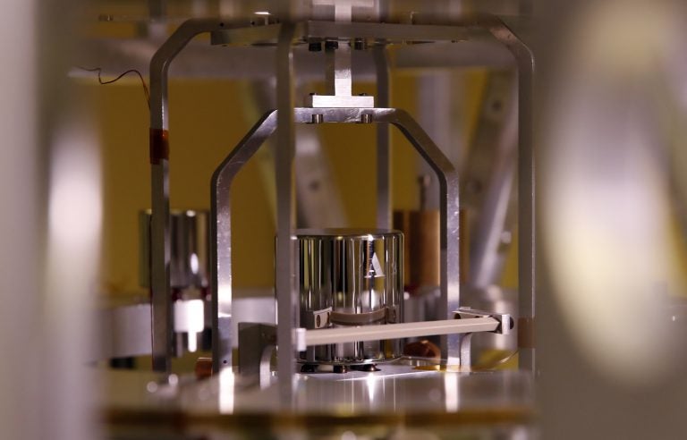 In this photo taken Wednesday, Oct. 17, 2018, a weight is set up at the International Bureau of Weights and Measures, in Sevres, near Paris. The golf ball-sized metal cylinder at the heart of the world's system for measuring mass is heading into retirement. Gathering this week in Versailles, west of Paris, governments on Friday Nov. 16, 2018, are expected to approve a plan to instead use a scientific formula to define the exact weight of a kilo. (Christophe Ena/AP Photo)