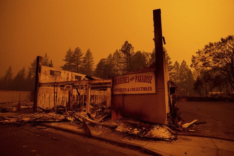 The walls of a scorched antique shop stand on Skyway after a wildfire burned through Paradise, Calif., on Friday, Nov. 9, 2018. (AP Photo/Noah Berger)