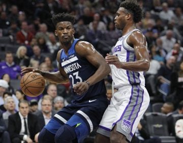 Minnesota Timberwolves guard Jimmy Butler (23) battles for position against Sacramento Kings guard Buddy Hield (24) during the first half of an NBA basketball game in Sacramento, Calif., Friday, Nov. 9, 2018. (Steve Yeater/AP Photo)