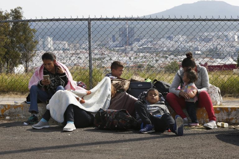 Central American migrants rest outside a soccer stadium after arriving in Queretaro, Mexico, as they resume their journey north, Saturday, Nov. 10, 2018. Thousands of Central American migrants were back on the move toward the U.S. border Saturday, after dedicated Mexico City metro trains whisked them to the outskirts of the capital and drivers began offering rides north. (AP Photo/Marco Ugarte)