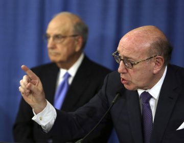 Ken Feinberg addresses a reporter's question during a news conference Tuesday Nov. 13, 2018, in Philadelphia. Feinberg and Camille Biros, not pictured, are administrators of claims submitted to the Independent Reconciliation and Reparations Program, a new clergy child sexual abuse victim compensation fund set up by the Roman Catholic Archdiocese of Philadelphia. George Mitchell, background, is chairing the committee. (Jacqueline Larma/AP Photo)