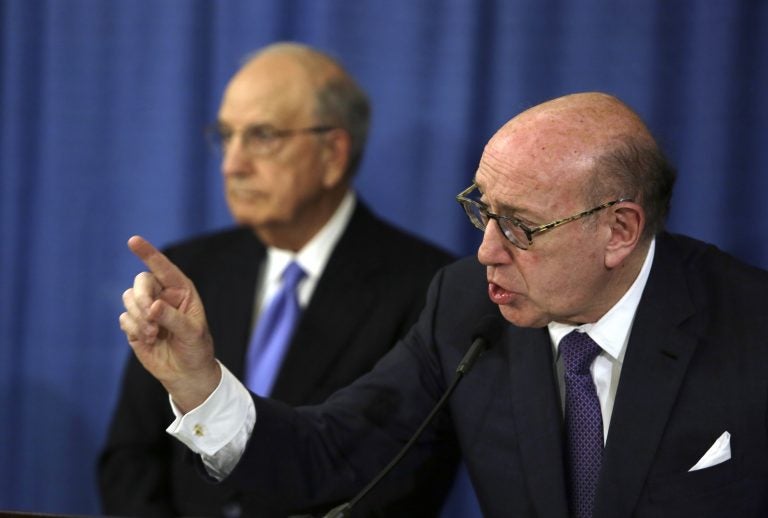 Ken Feinberg addresses a reporter's question during a news conference Tuesday Nov. 13, 2018, in Philadelphia. Feinberg and Camille Biros, not pictured, are administrators of claims submitted to the Independent Reconciliation and Reparations Program, a new clergy child sexual abuse victim compensation fund set up by the Roman Catholic Archdiocese of Philadelphia. George Mitchell, background, is chairing the committee. (Jacqueline Larma/AP Photo)