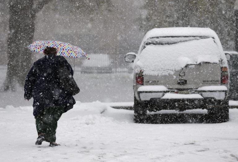 A pedestrian makes her way through wintry weather in Mt. Holly, N.J., Thursday, Nov. 15, 2018. A mix of rain, sleet and snow started falling late Thursday morning in southern areas and was expected to soon move across the state. (Seth Wenig/AP Photo)