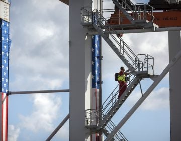 In this July, 5, 2018, file photo, a rubber tire gantry operator climb steps to his cab at the start of his work shift at the Port of Savannah in Savannah, Ga. (Stephen B. Morton/AP Photo)