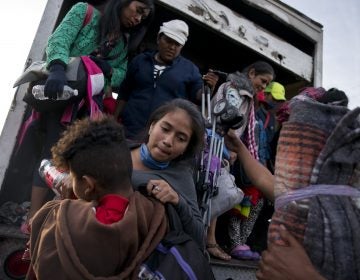 Migrants arrive to Tijuana after traveling in a truck from Mexicali, part of the migrant caravan, in Mexico, Tuesday, Nov. 27, 2018. Tension continued Tuesday as residents in the Mexican border city of Tijuana closed down a school next to a sports complex where more than 5,000 Central American migrants have been camped out for two weeks. (Ramon Espinosa/AP Photo)