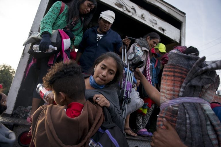 Migrants arrive to Tijuana after traveling in a truck from Mexicali, part of the migrant caravan, in Mexico, Tuesday, Nov. 27, 2018. Tension continued Tuesday as residents in the Mexican border city of Tijuana closed down a school next to a sports complex where more than 5,000 Central American migrants have been camped out for two weeks. (Ramon Espinosa/AP Photo)