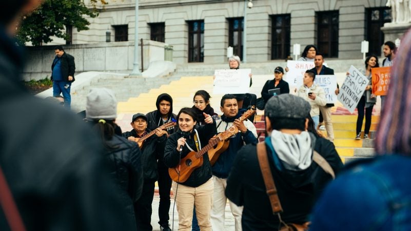 Yared Portillo sings with people gathered during the 