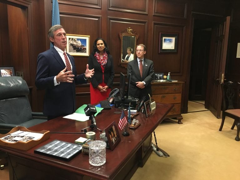 Delaware Gov. John Carney talks about soaring health care costs before signing an executive order in his Wilmington office. (Mark Eichmann/WHYY)