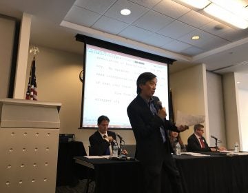 Andy Toy, on behalf of United Voices of Philadelphia warms up the crowd before a candidate’s forum geared towards immigrant voters. (Laura Benshoff/WHYY)