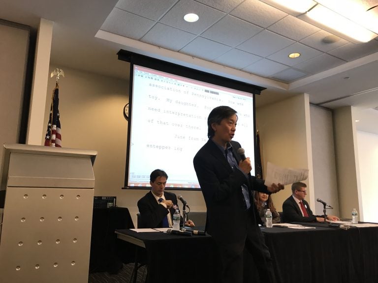 Andy Toy, on behalf of United Voices of Philadelphia warms up the crowd before a candidate’s forum geared towards immigrant voters. (Laura Benshoff/WHYY)