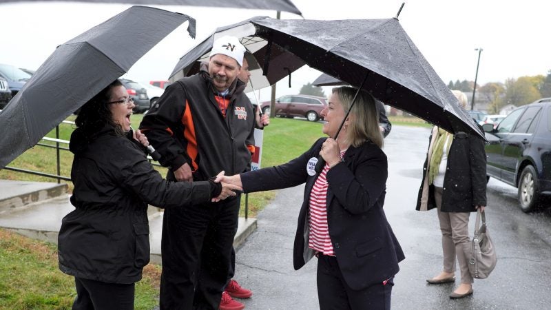 Susan Wild, right, Democratic candidate for Pennsylvania's new 7th Congressional District, talks to the parents of Democratic candidate for State Rep. Jason Ruff on Nov. 6, 2018, outside Allen Township Fire Department in Northampton, Pennsylvania. (Matt Smith for WHYY)