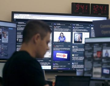 A man works at his desk in front of monitors last month during a demonstration in the war room, where Facebook monitors election-related content on the platform, in Menlo Park, Calif. (Jeff Chiu/AP)