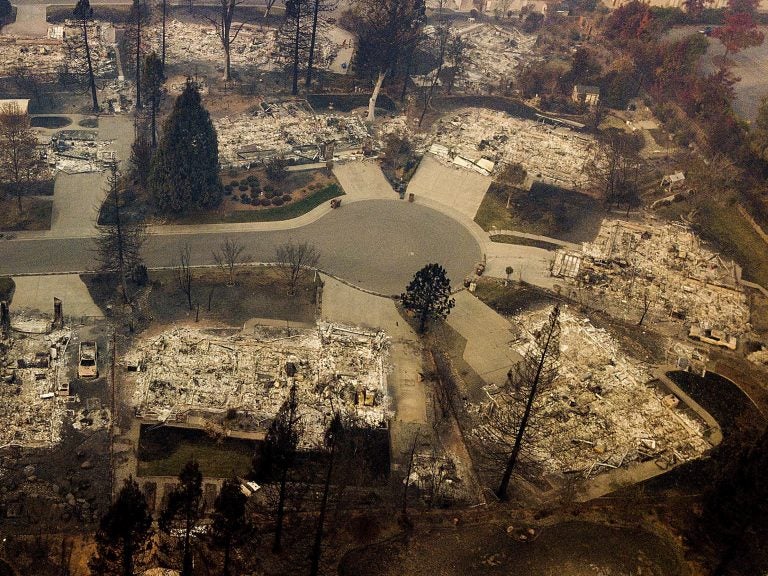 Residences leveled by the Camp Fire line a cul-de-sac in Paradise, Calif., earlier this month. A massive federal report says climate change is contributing to larger wildfires as well as other deadly extreme weather.
(Noah Berger/AP)