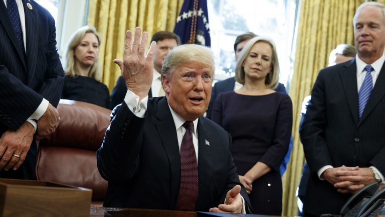 President Trump answers a reporter's question about the investigation of special counsel Robert Mueller during a bill signing ceremony in the Oval Office Friday. (Evan Vucci/AP)