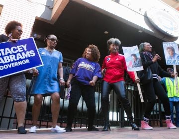 Georgia voters and supporters dance and sing during a 