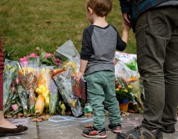 Mourners visit the memorial outside the Tree of Life Synagogue in Pittsburgh after eleven people were killed in a mass shooting last weekend. Security remains tightened as congregations prepare to celebrate Shabbat.  (Jeff Swensen/Getty Images)