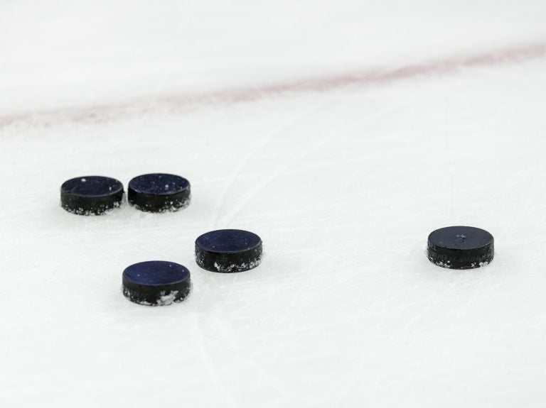 Hockey pucks on ice at Nationwide Arena in Columbus, Ohio (Adam Lacy/Icon Sportswire via Getty Images)