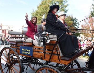 Kathy Jennings waves to the Return Day crowd in 2018, two days after being elected attorney general, while riding in a horse-drawn carriage from  Marvel Carriage Museum. (WHYY file)