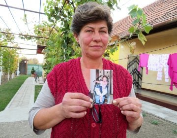 Liliana Czegledi holds a photo of her daughter, Ioana, at her home in the village of Sînandrei in western Romania. Ioana was just shy of her 10th birthday when she died of complications from measles. She could not be vaccinated because she had a compromised immune system. (Joanna Kakissis for NPR)