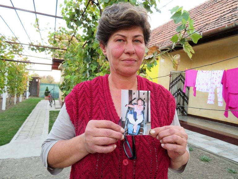 Liliana Czegledi holds a photo of her daughter, Ioana, at her home in the village of Sînandrei in western Romania. Ioana was just shy of her 10th birthday when she died of complications from measles. She could not be vaccinated because she had a compromised immune system. (Joanna Kakissis for NPR)