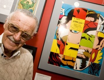 Comic book legend Stan Lee poses at the opening reception for 