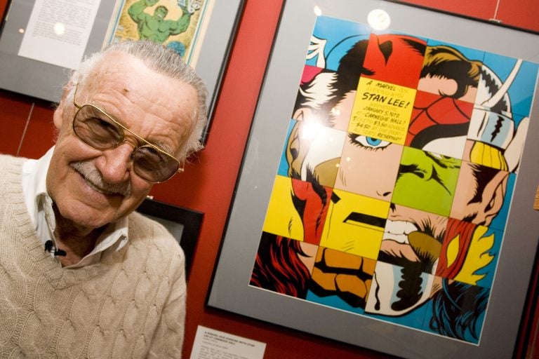 Comic book legend Stan Lee poses at the opening reception for 