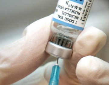 A nurse draws a dose of mumps-measles-rubella, or MMR, vaccine. (AP Photo/The Wichita Eagle, Mike Hutmacher, 2006 file)