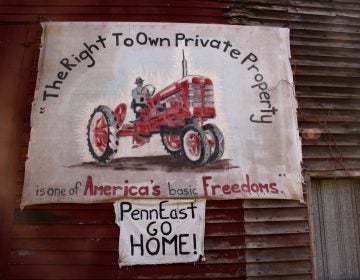 A sign on the side of a barn on Riegelsville Road in Holland Township, New Jersey, shows local opposition to the PennEast pipeline. (Emma Lee/WHYY)