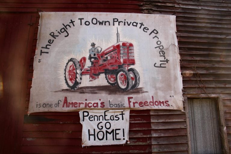 A sign on the side of a barn on Riegelsville Road in Holland Township, New Jersey, shows local opposition to the PennEast pipeline. (Emma Lee/WHYY)