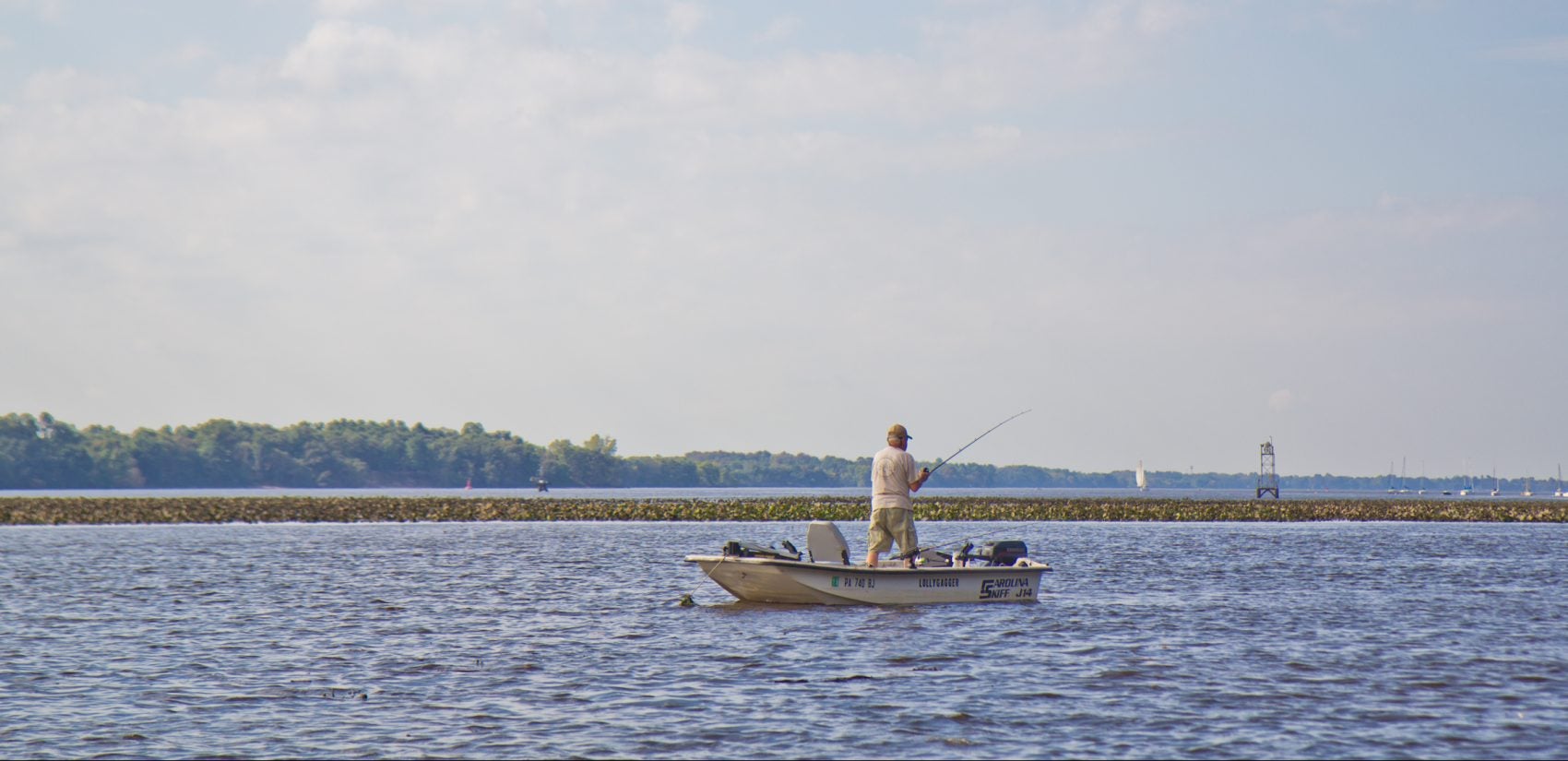 File photo: A member of the Delaware River Fishermen's Association fishes for catfish in Bucks County. (Kimberly Paynter/WHYY)