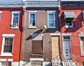 Philadelphia Police Detective Lawrence Greene bought 2931 Waterloo Street, center, in an auction of property seized by the District Attorney. The DA was empowered to take homes connected to alleged drug activity without a guilty verdict. The house is vacant today. (Kimberly Paynter/WHYY)