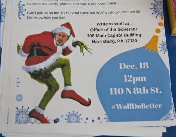 A grinch Governor Wolf appears on a flyer inviting Philadelphians to create holiday cards to send to Governor Wolf asking him to end a DOC policy that doesn’t allow families to send cards of photos to incarcerated family members. (Kimberly Paynter/WHYY)