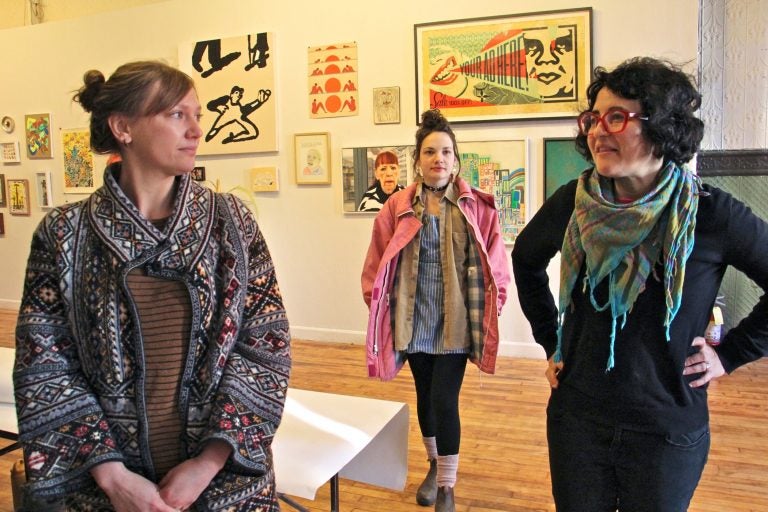 Artists from Space 1026, (from left) Jacqueline Quinn, Rachel Gordon and Miriam Singer, prepare for the collective's final auction at 1026 Arch Street in Chinatown. A steep rent increase has driven them to seek space elsewhere.