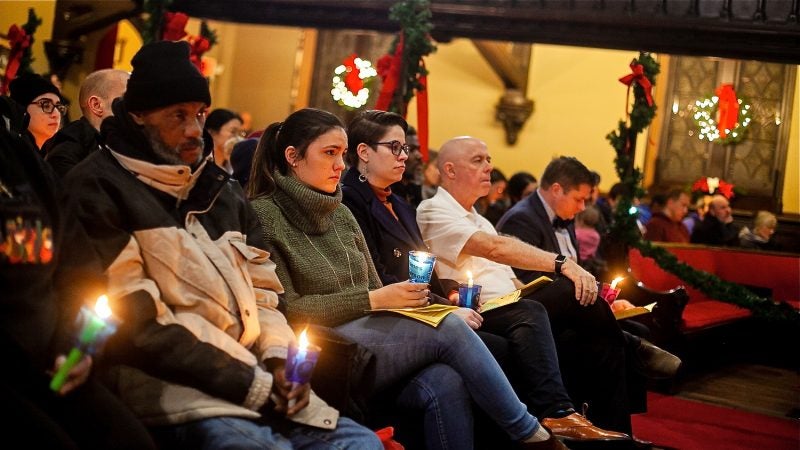 Philadelphians, some formerly and currently homeless, attended a Homeless Memorial Day service at Arch Street United Methodist Church Thursday evening. (Brad Larrison for WHYY)
