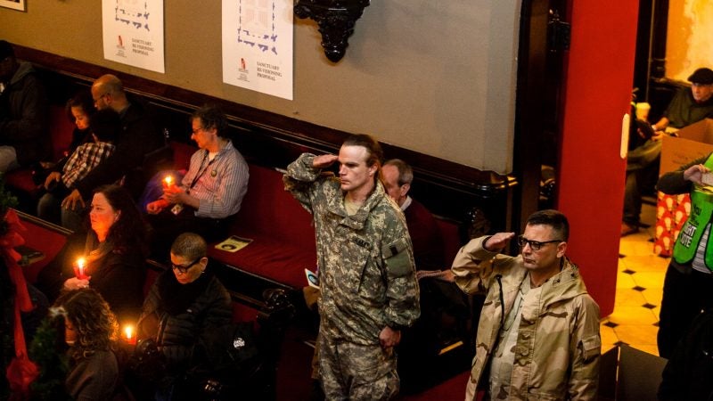 The names of 270 homeless Philadelphians, many of them veterans, who died in the past year are read at a Homeless Memorial Day service at Arch Street United Methodist Church Thursday evening. (Brad Larrison for WHYY)