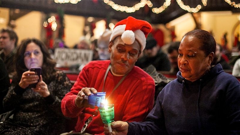 Candles are lit in memory of those who have died living on the streets of Philadelphia at a Homeless Memorial Day Service at Arch Street United Methodist Church Thursday evening. (Brad Larrison for WHYY)