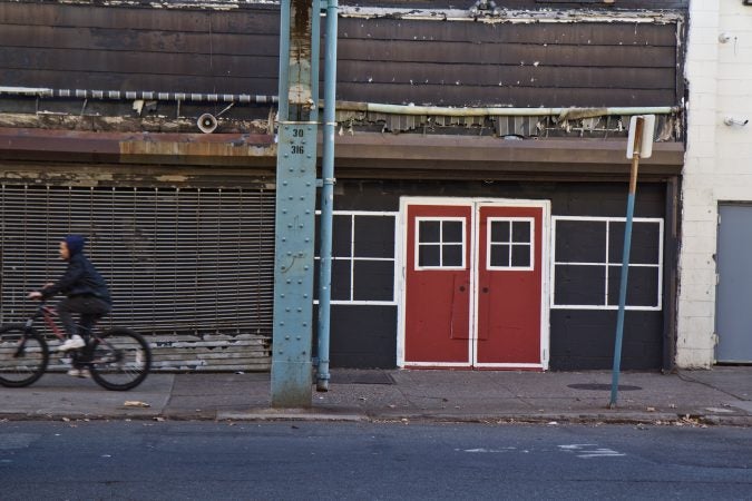 Boarded buildings are painted to have faux doors and windows in Kensington. (Kimberly Paynter/WHYY)