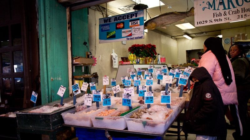 Tracey Prioleau and her family shop for Christmas fish at Marcos in the Italian Market. (Kimberly Paynter/WHYY)