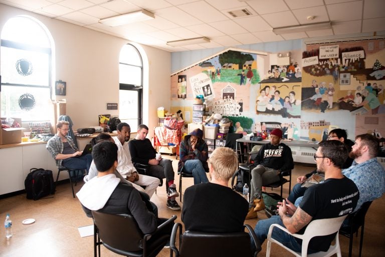 Participants in a masculinity workshop discuss a reading at Lutheran Settlement House on Sunday, October 28, 2018. (Kriston Jae Bethel for WHYY)