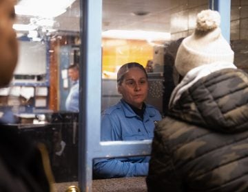 Officer Toledo from the 35th Police District informs James Shuler and other members of the Community Crisis Intervention Program that there have been no recorded instances of violent crime for the day. (Kriston Jae Bethel for WHYY)