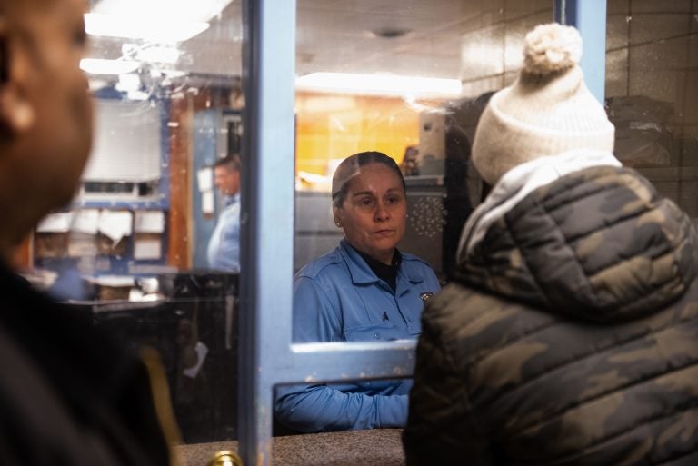 Officer Toledo from the 35th Police District informs James Shuler and other members of the Community Crisis Intervention Program that there have been no recorded instances of violent crime for the day. (Kriston Jae Bethel for WHYY)