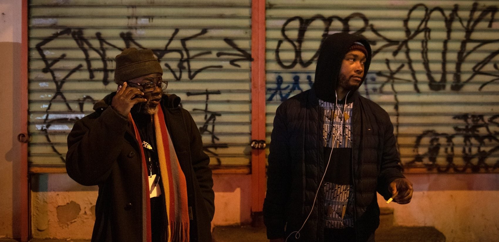 Samuel White assures the mother of Omar Smith that they'll make sure her son gets home safe, after stopping to talk to Smith on his way home from a convenience store. Smith previously survived being shot six times in his leg. (Kriston Jae Bethel for WHYY)